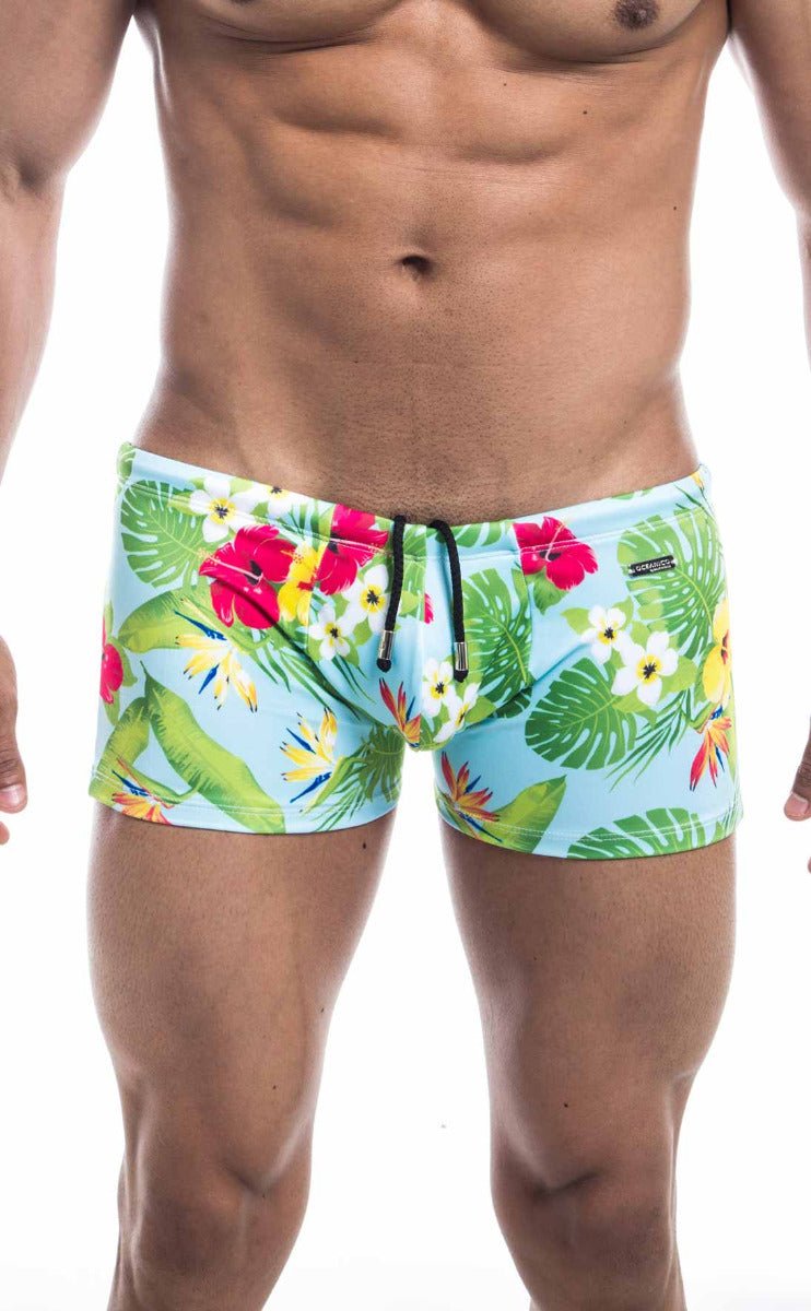 Oceanico Square Cut swim trunks in light blue with green leaves and pink red yellow tropical flower print