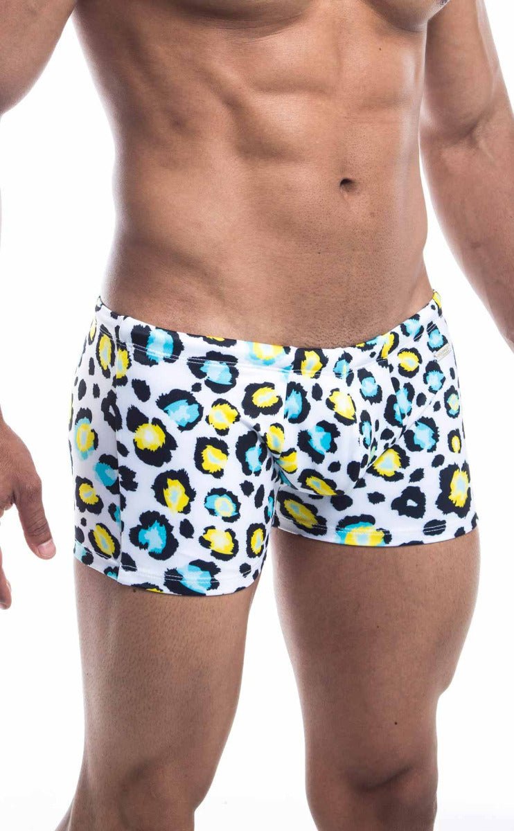 Oceanico square cut white swim trunks with bold leopard print and vibrant yellow and teal accents for beachwear
