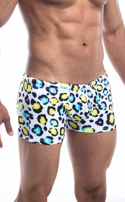 Oceanico square cut white swim trunks with bold leopard print and vibrant yellow and teal accents for beachwear