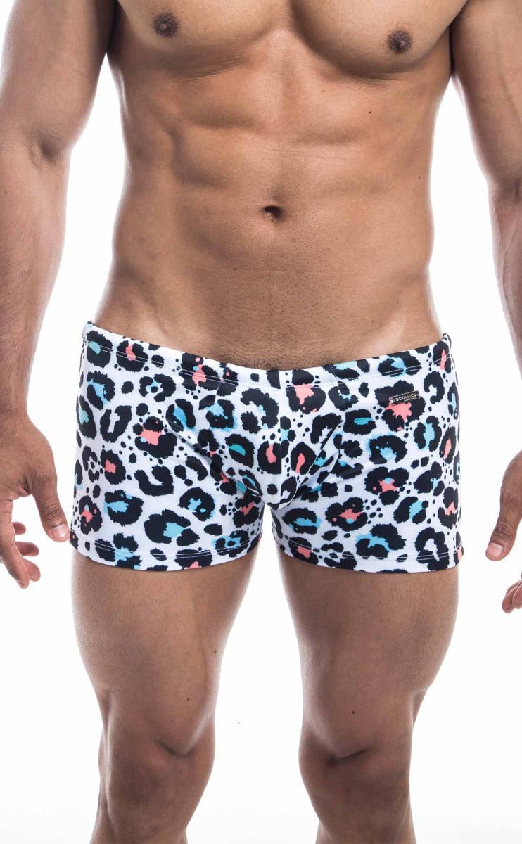 White Oceanico Square Cut swim trunks with bold leopard print featuring black pink and teal spots