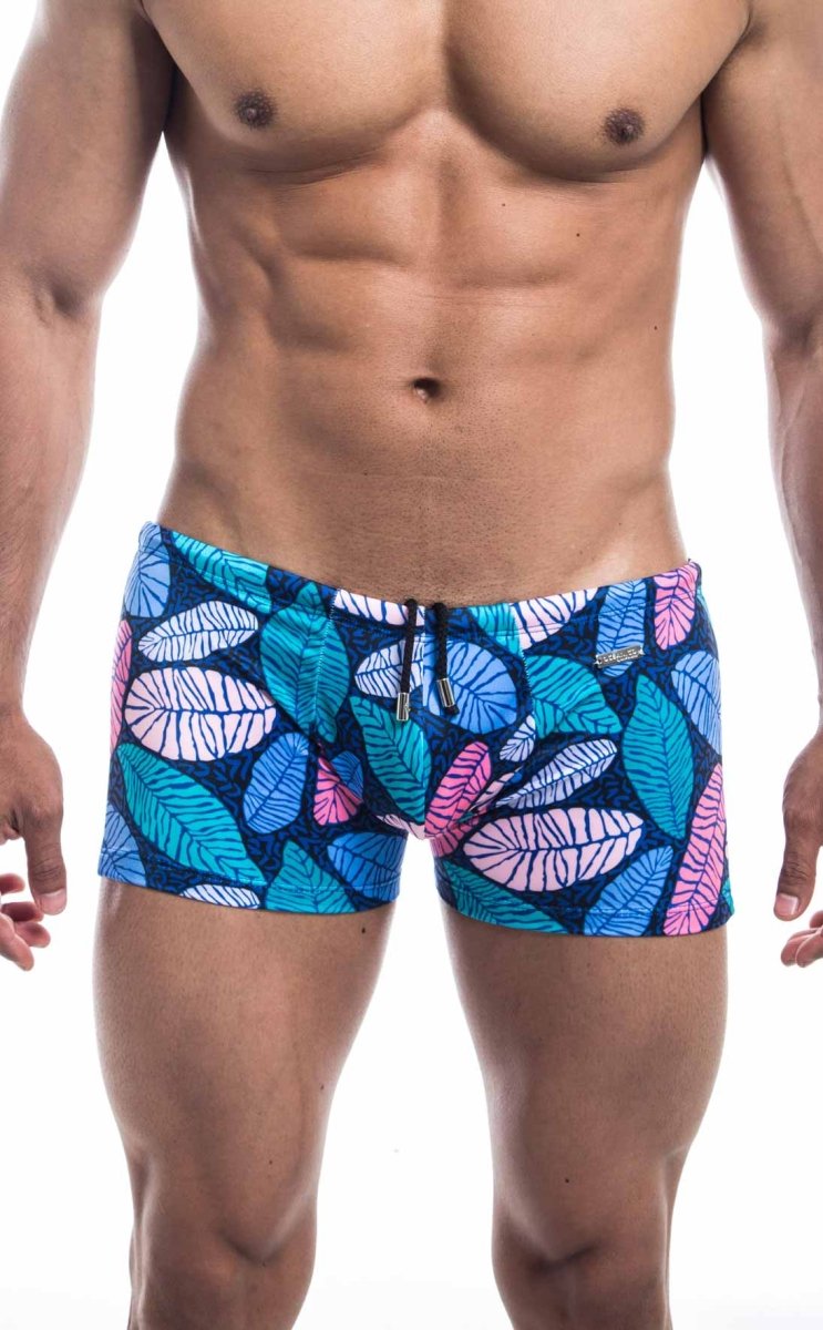 Oceanico square cut swim trunks with blue and pink leaf patterns on a dark blue base for beachwear