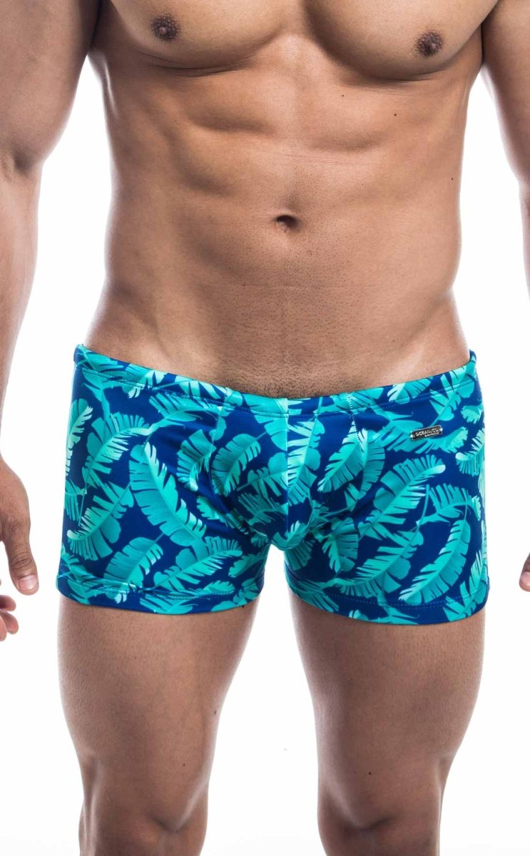 Oceanico square cut blue swim trunks with tropical leaf pattern and vibrant teal design for beachwear