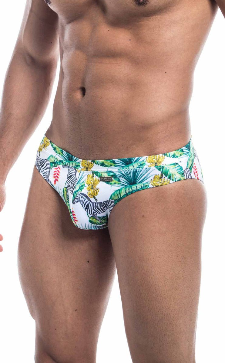 White Oceanico swim bikini trunks with vibrant tropical pattern featuring zebras green palm leaves and yellow flowers