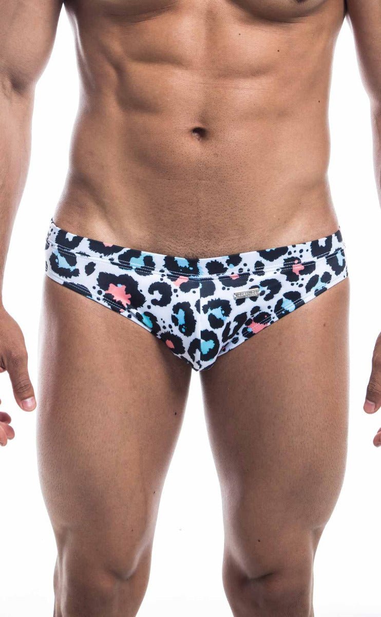 White Oceanico swim bikini swim trunks with bold leopard print black spots and bright blue and pink accents
