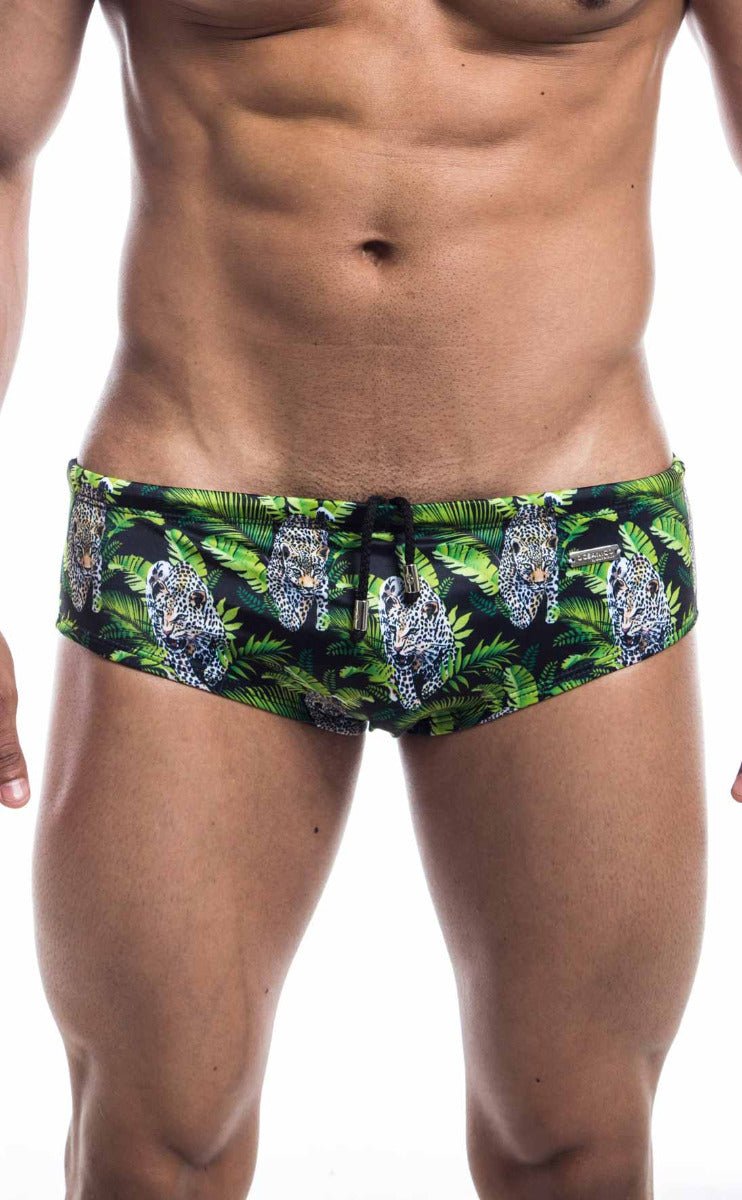 Oceanico swim brief in green and black with vibrant jungle pattern featuring white-spotted leopards and lush foliage