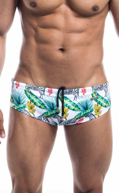 Oceanico swim brief featuring white fabric with a vibrant tropical pattern of green palm leaves yellow flowers and zebras