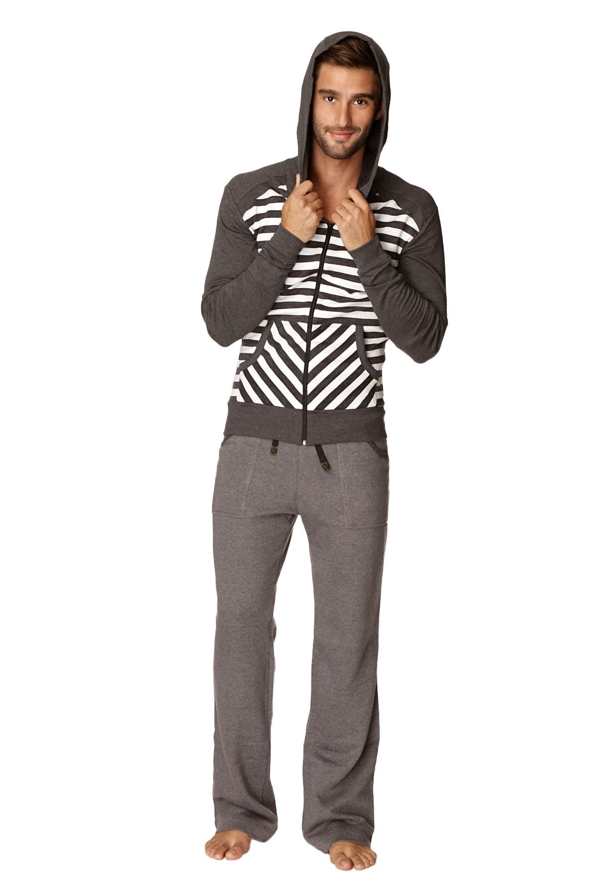 A man wearing an original limited edition form-fit crossover yoga track charcoal stripe fleece hoodie with matching pants