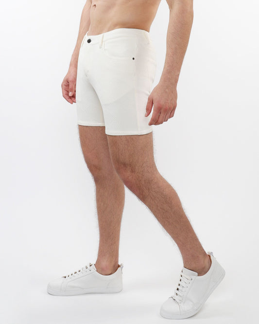 White parquet jacquard stretch knit shorts with textured fabric and black button closures