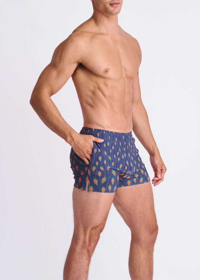 Blue patterned seersucker swim shorts with orange and yellow leaf motifs and mesh lining