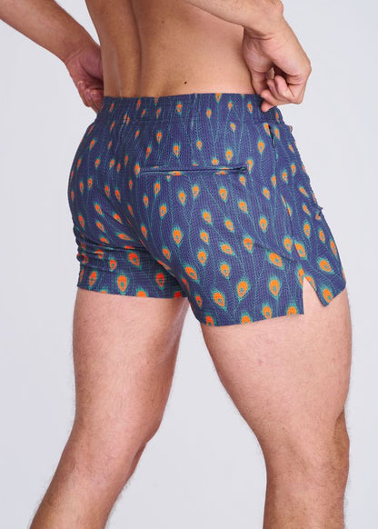 Blue seersucker swim shorts with vibrant orange and teal peacock feather pattern elastic waistband and side slit with mesh lining