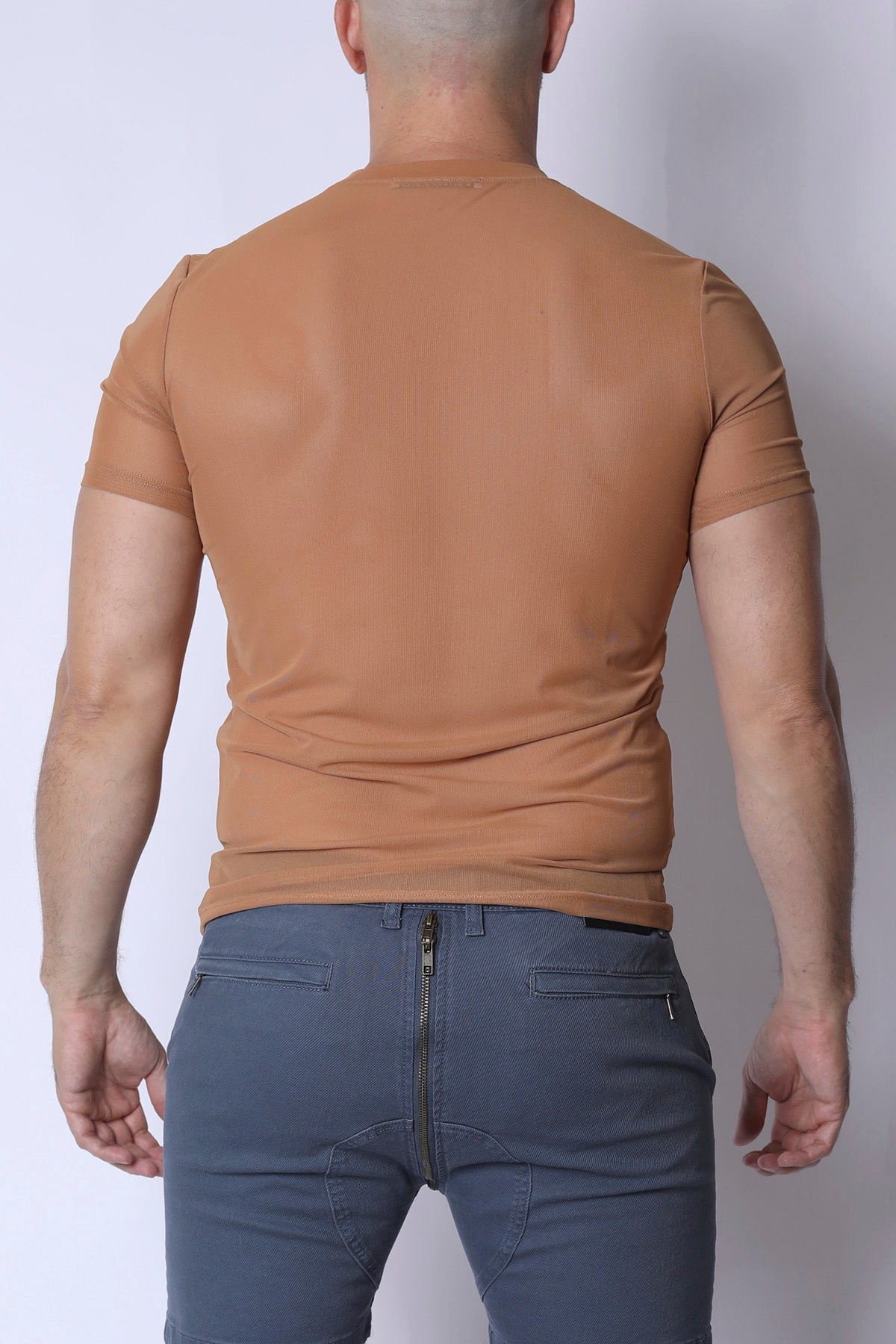 A fitted tan phantom mesh t-shirt with short sleeves and a crew neck made from breathable material
