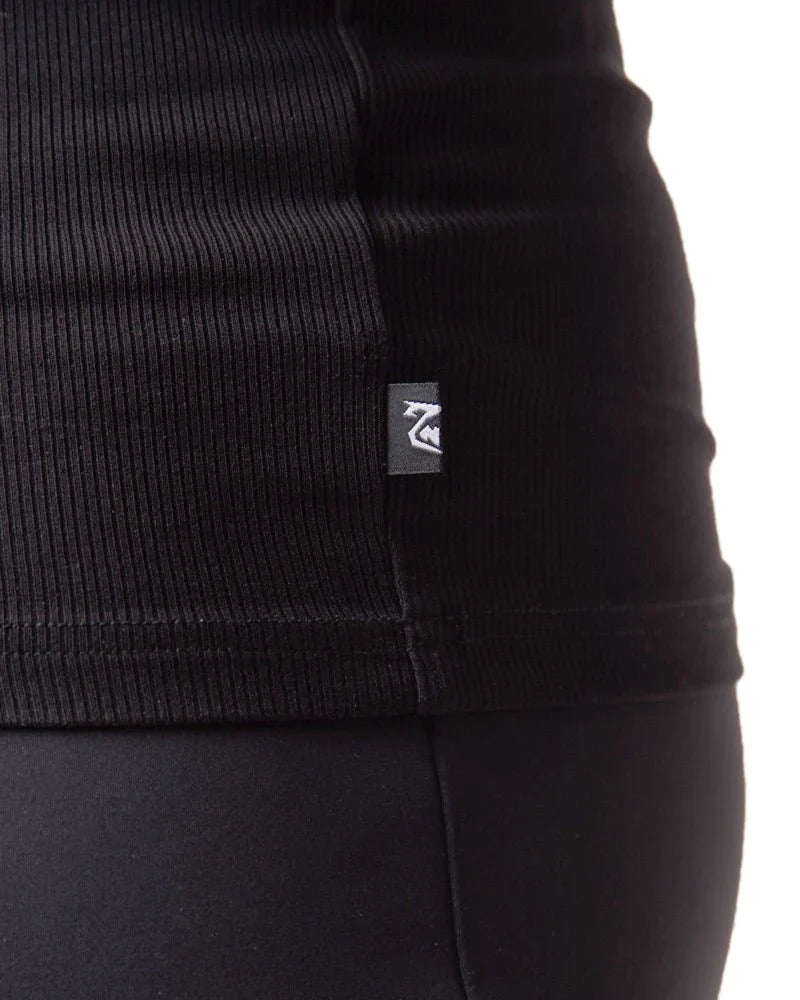 Black ribbed knit pig rib tank top with small rectangular brand tag on the seam showing the front side
