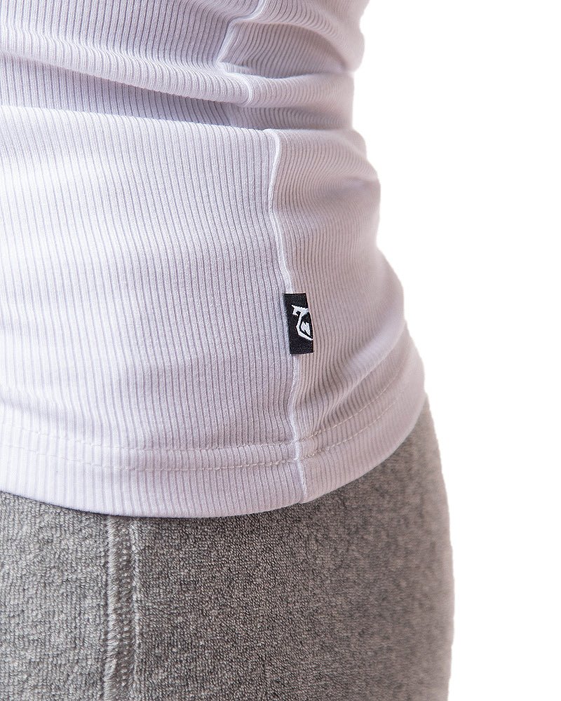 White ribbed knit pig rib tank top with small black logo tag at the hem
