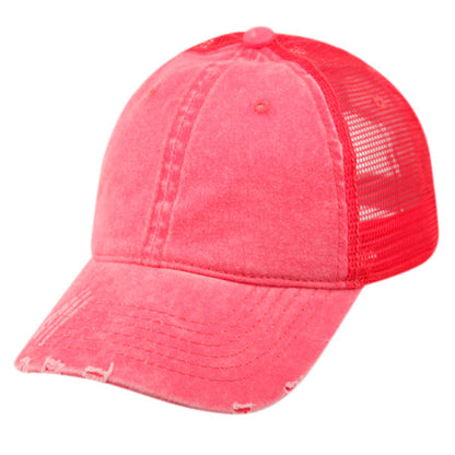 A vibrant coral pink pigment dyed washed cotton trucker cap with distressed front and matching mesh back