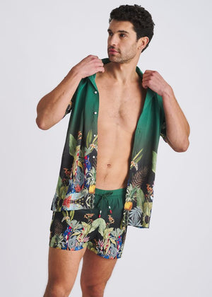 Emerald-green and multi-colored fauna print swim shorts with a drawstring waist and matching shirt.