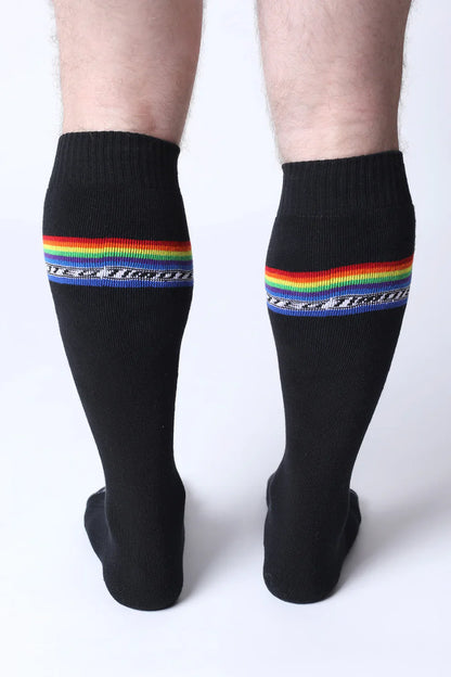 Black pride knee high socks with vibrant rainbow stripe and white military text below the stripe