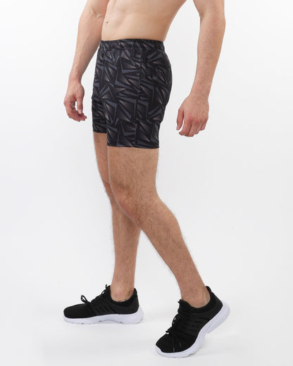 Black printed mesh stretch performance shorts with geometric leaf pattern made of lightweight fabric