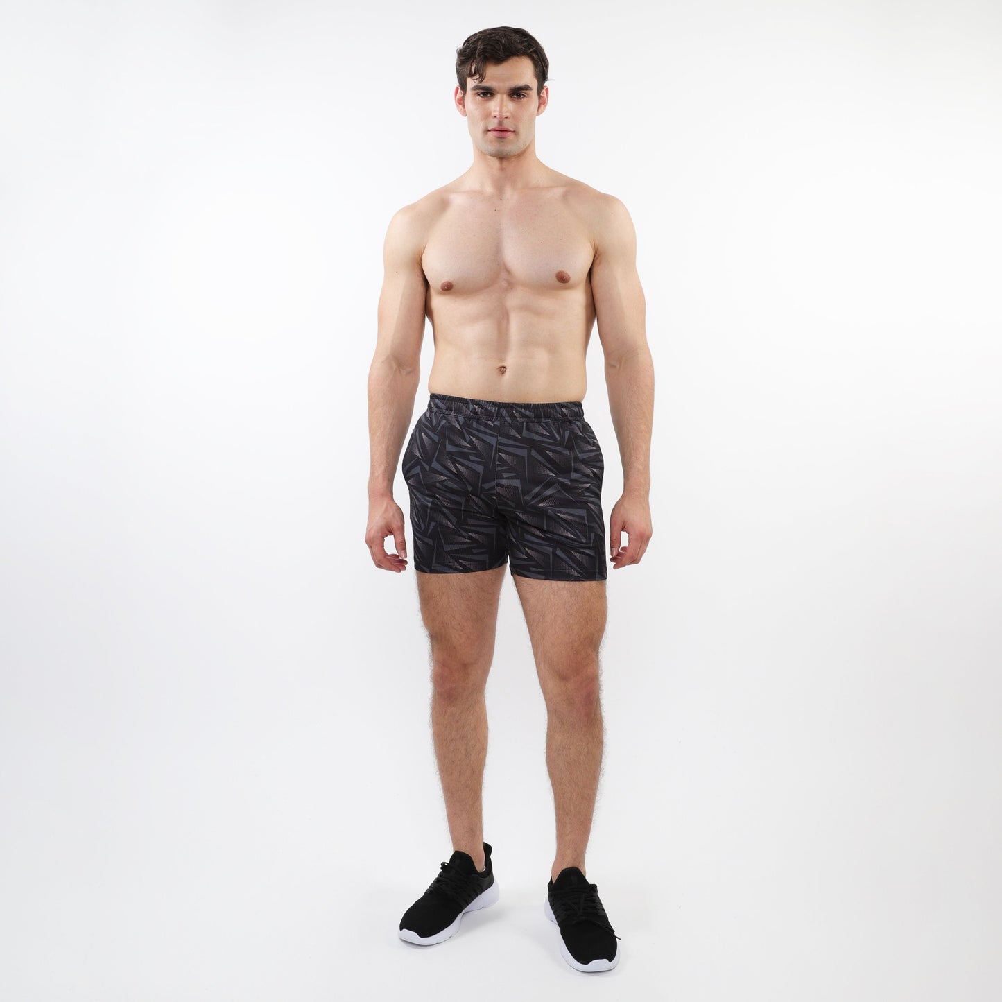 Black printed mesh stretch performance shorts with subtle geometric leaf pattern made from lightweight athletic fabric