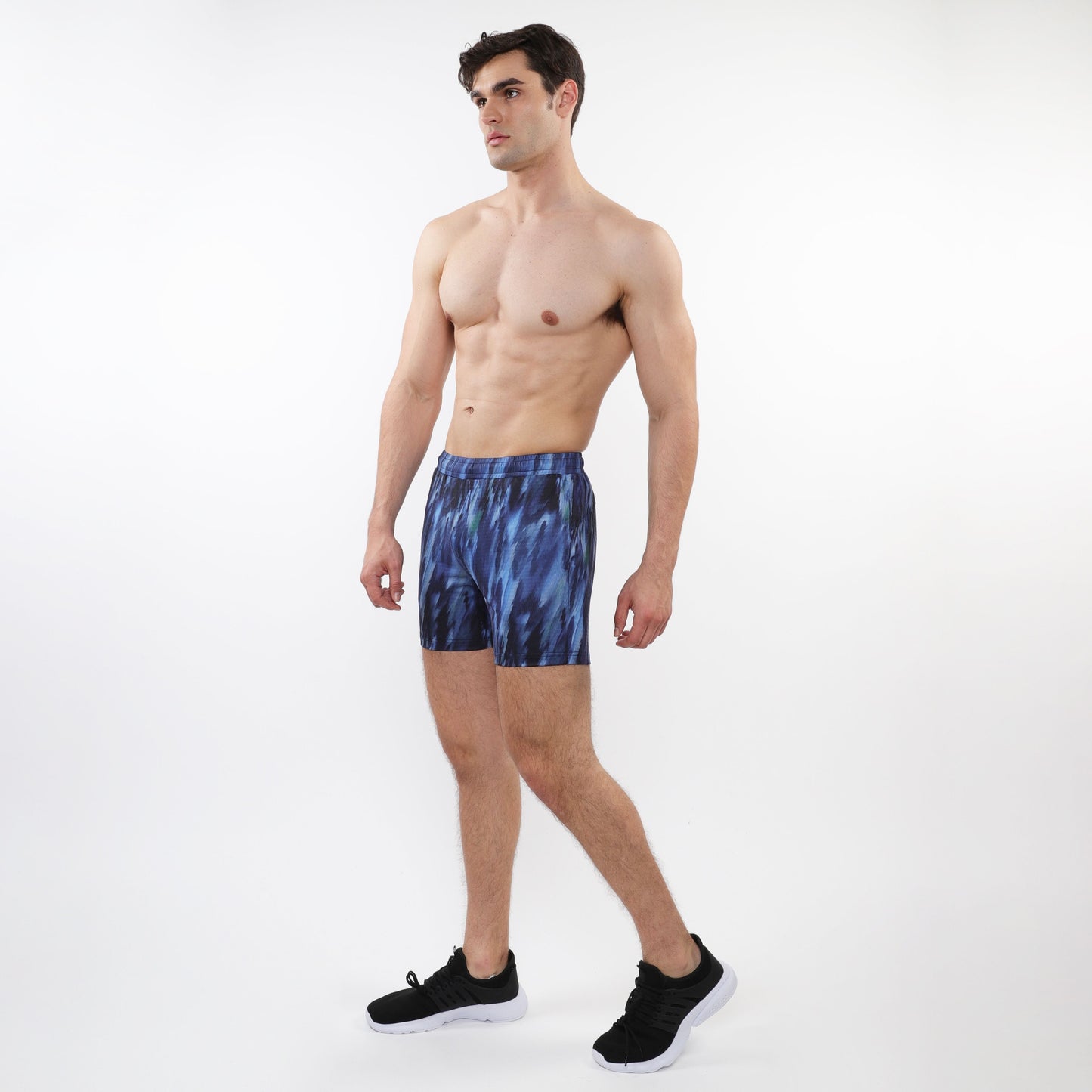 Printed mesh stretch performance shorts in blue tie-dye with a snug fit and elastic waistband for athletic use