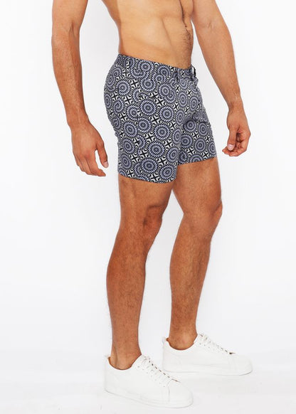 Printed stretch knit short swim trunks in blue and white geometric patterned fabric designed for comfort and style