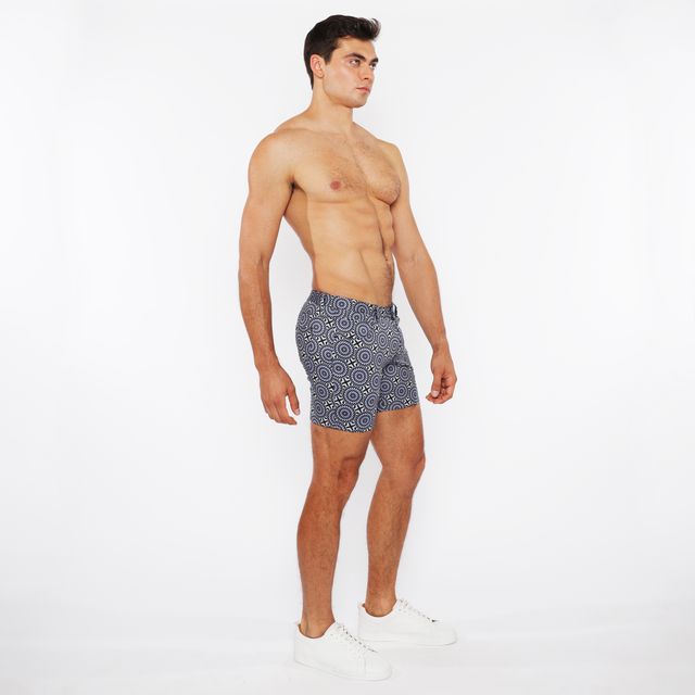 Navy blue printed stretch knit short swim trunks with white geometric pattern for comfortable beachwear