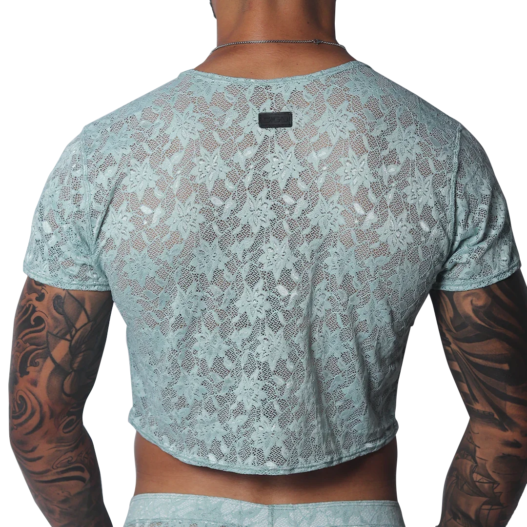 Aqua floral lace crop top with short sleeves and a small black brand tag at the back neckline.