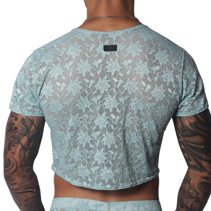 Aqua floral lace crop top with short sleeves and a small black brand tag at the back neckline.