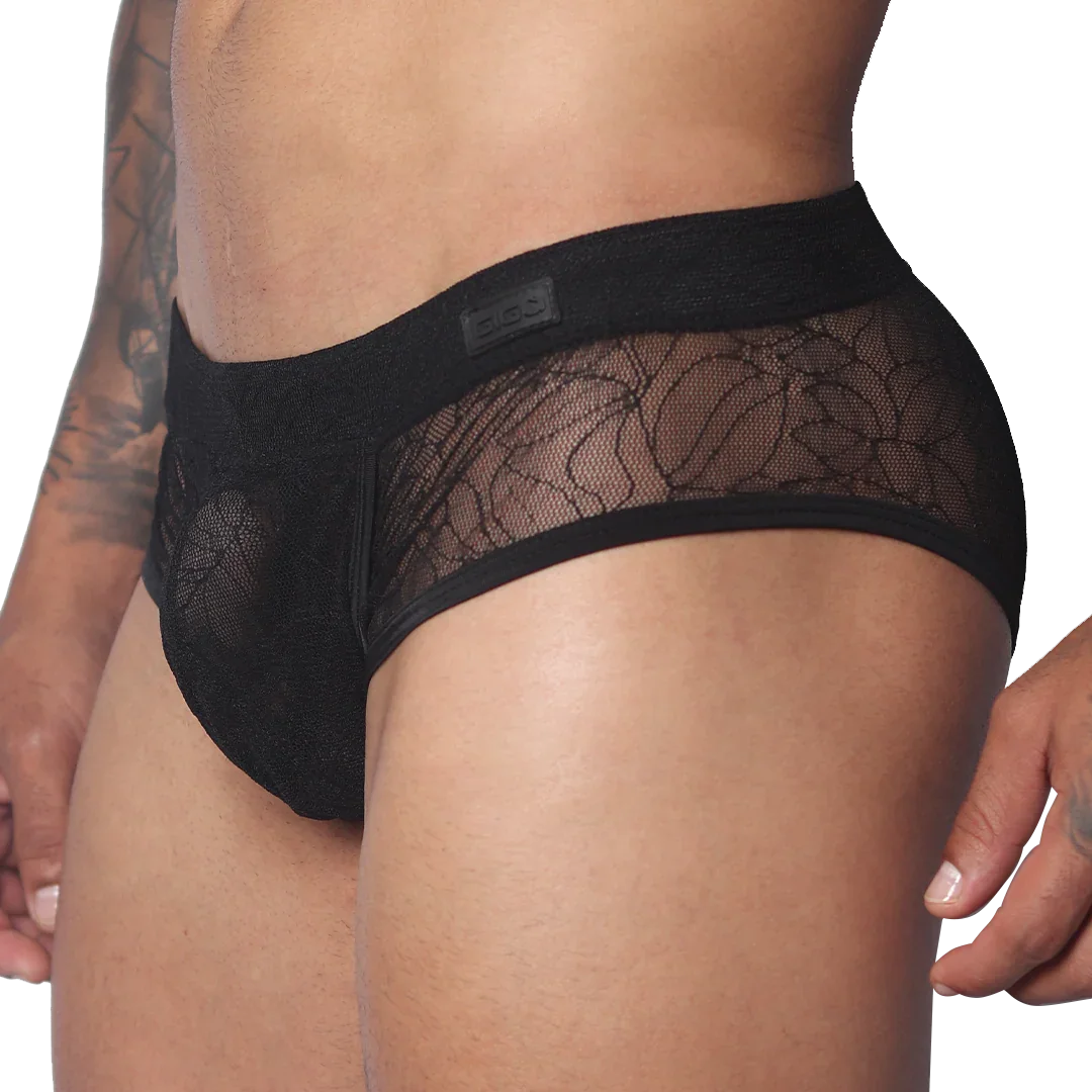 Black men's trunk with floral lace panels, solid waistband featuring a Gigo logo patch, and a contoured pouch design.