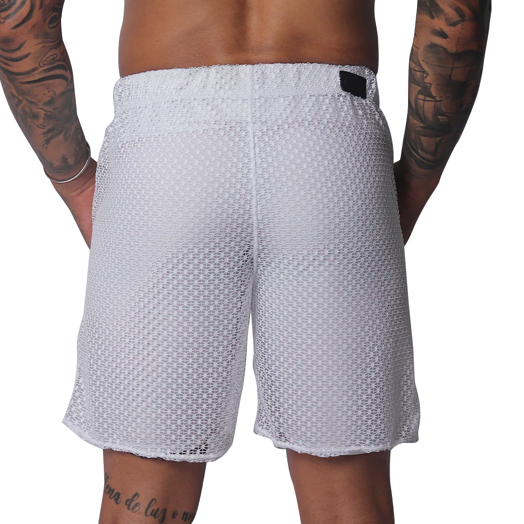 White mesh athletic shorts with an elastic waistband and a small black rectangular brand patch on the back.