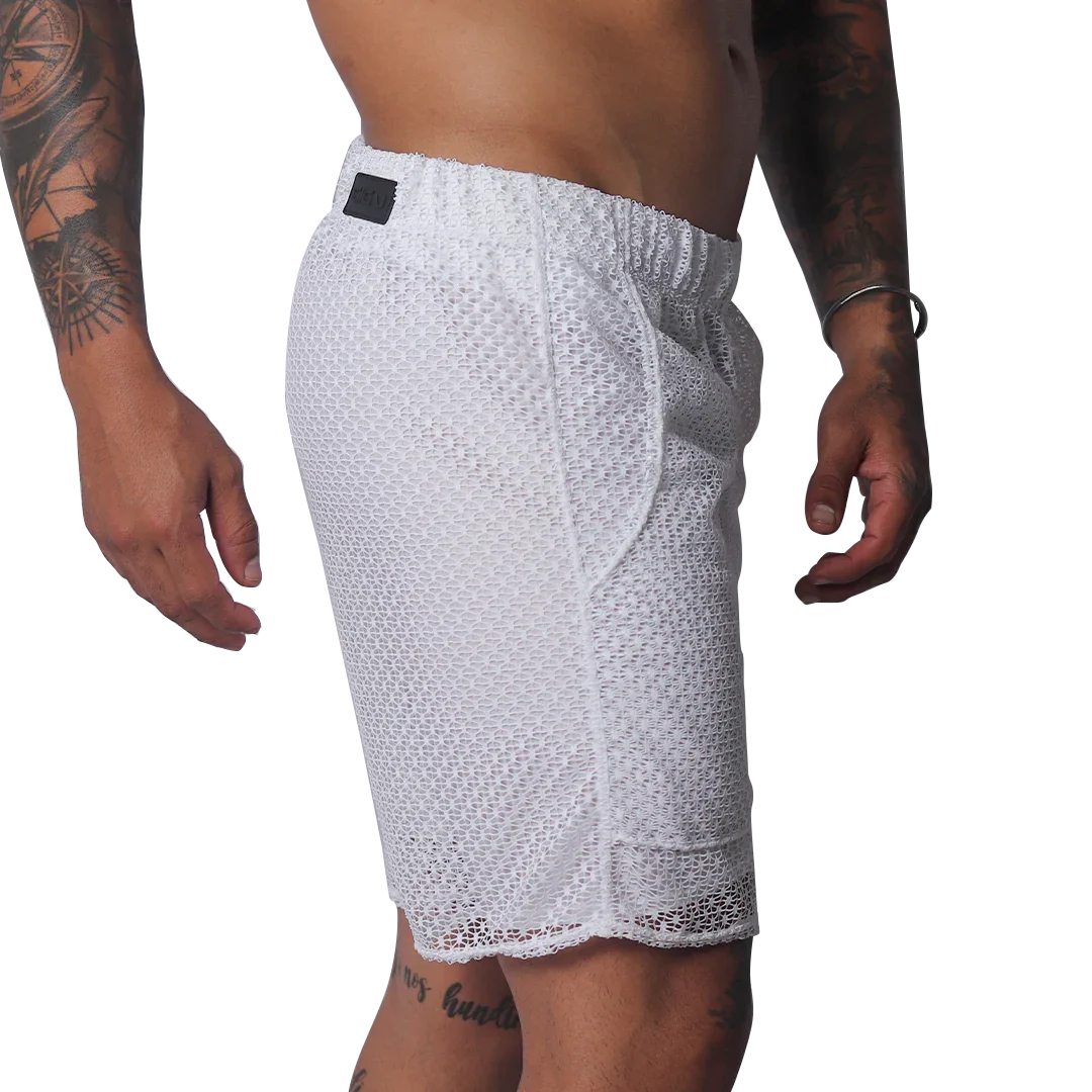 White athletic shorts made of a sheer, open-mesh material with an elastic waistband and small black logo patch.