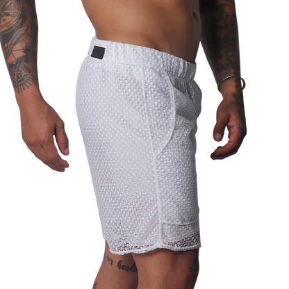 White athletic shorts made of a sheer, open-mesh material with an elastic waistband and small black logo patch.