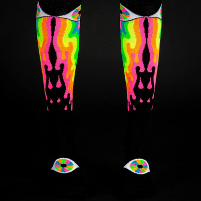 Psychedelic eye knee high socks featuring neon flame patterns with black silhouettes and eye motifs at the toes