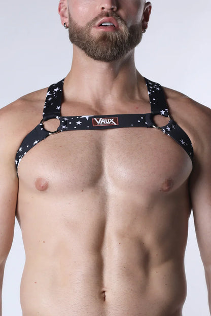 Black star-patterned pulse elastic harness with metallic rings and vaux brand label for stylish support