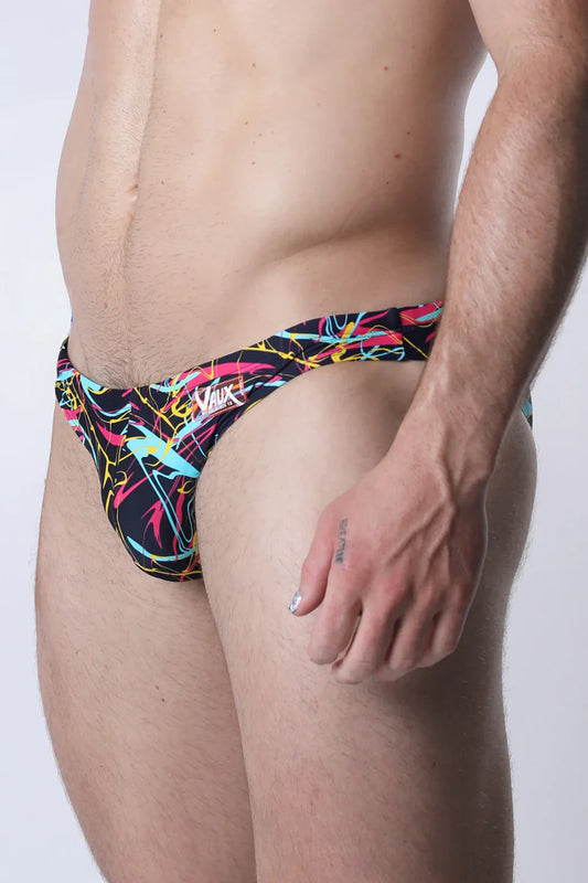 Vaux pulse swim brief men’s trunks with bold neon pink yellow cyan abstract lines on black fabric for swimming