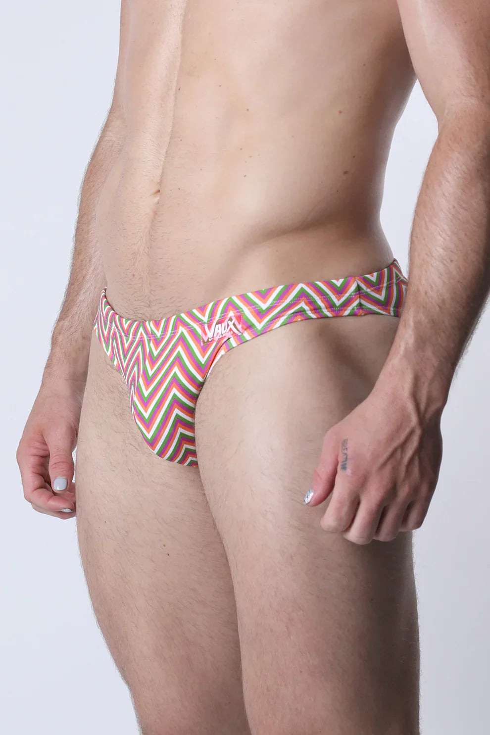 Vaux pulse swim brief featuring bold red green and white zigzag patterned men’s swim trunks