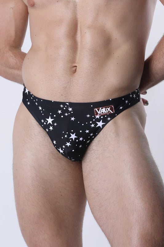 Black star-patterned men’s pulse swim thong briefs with red and white vaux label on the waistband