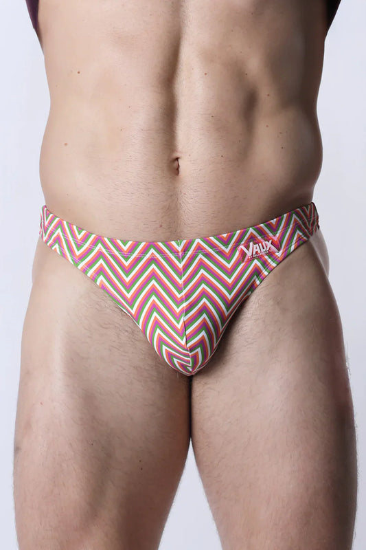 Vaux pulse swim thong men’s swim trunks with bold red green and white zigzag pattern for beach and pool use