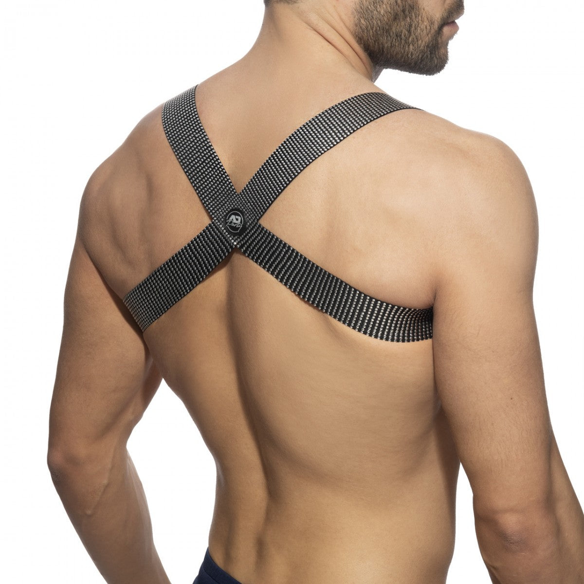 Black mesh crossback strap with skull logo at center shown on the back of pushpin spider harness
