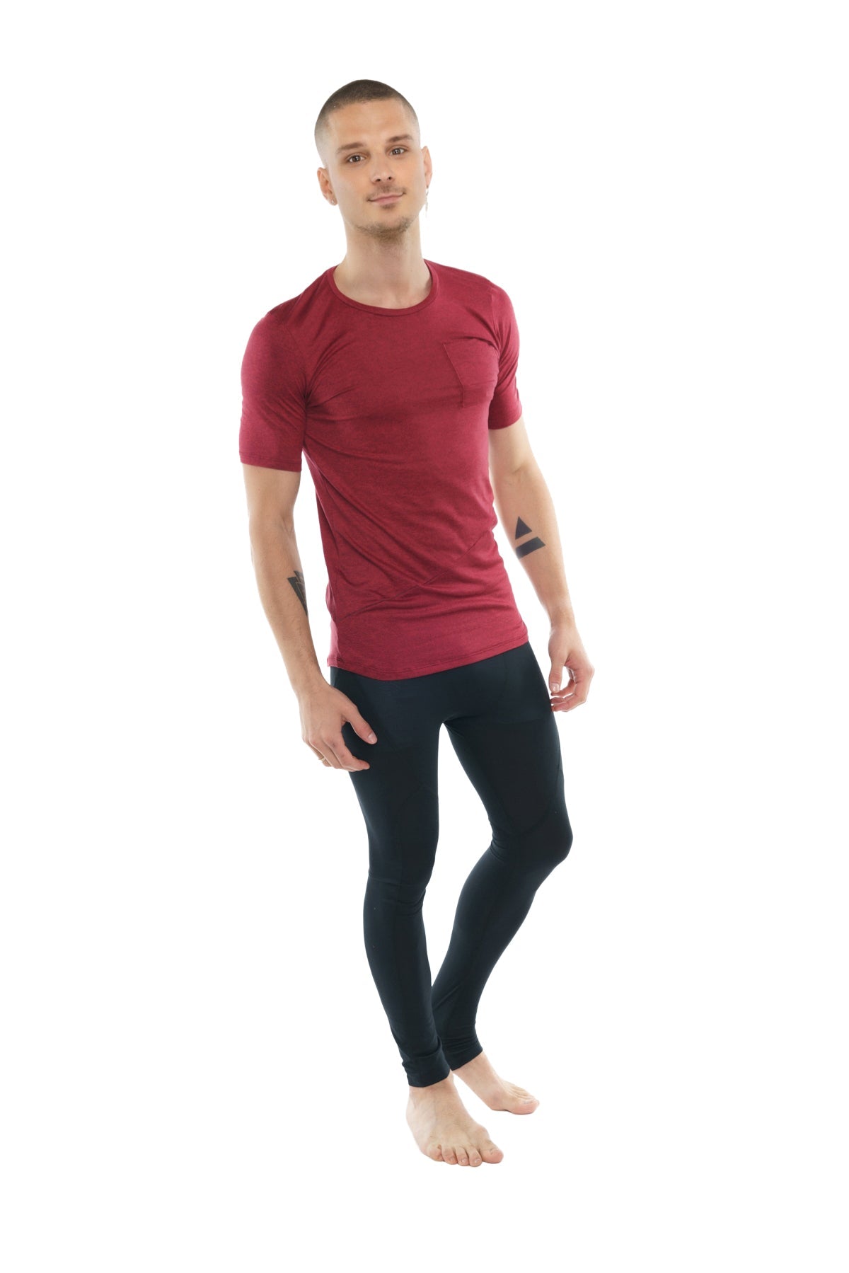 A man wearing a fitted brick red heather perfect pocket crew-neck tee and black athletic leggings