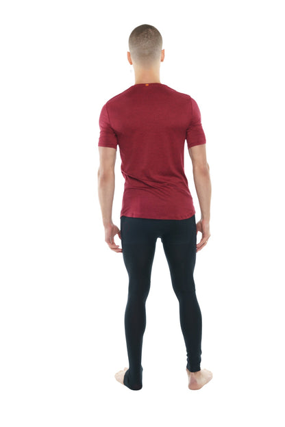 A man wearing a brick red heather perfect pocket crew-neck tee with black leggings showing the front side
