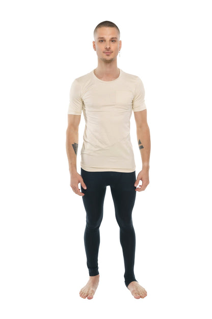 A man wearing a beige perfect pocket crew-neck tee with short sleeves and black fitted leggings