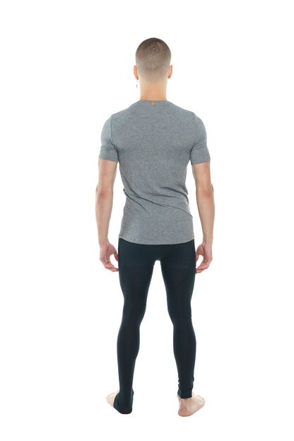 A man wearing a heather gray perfect pocket crew-neck tee in steel heather with black leggings