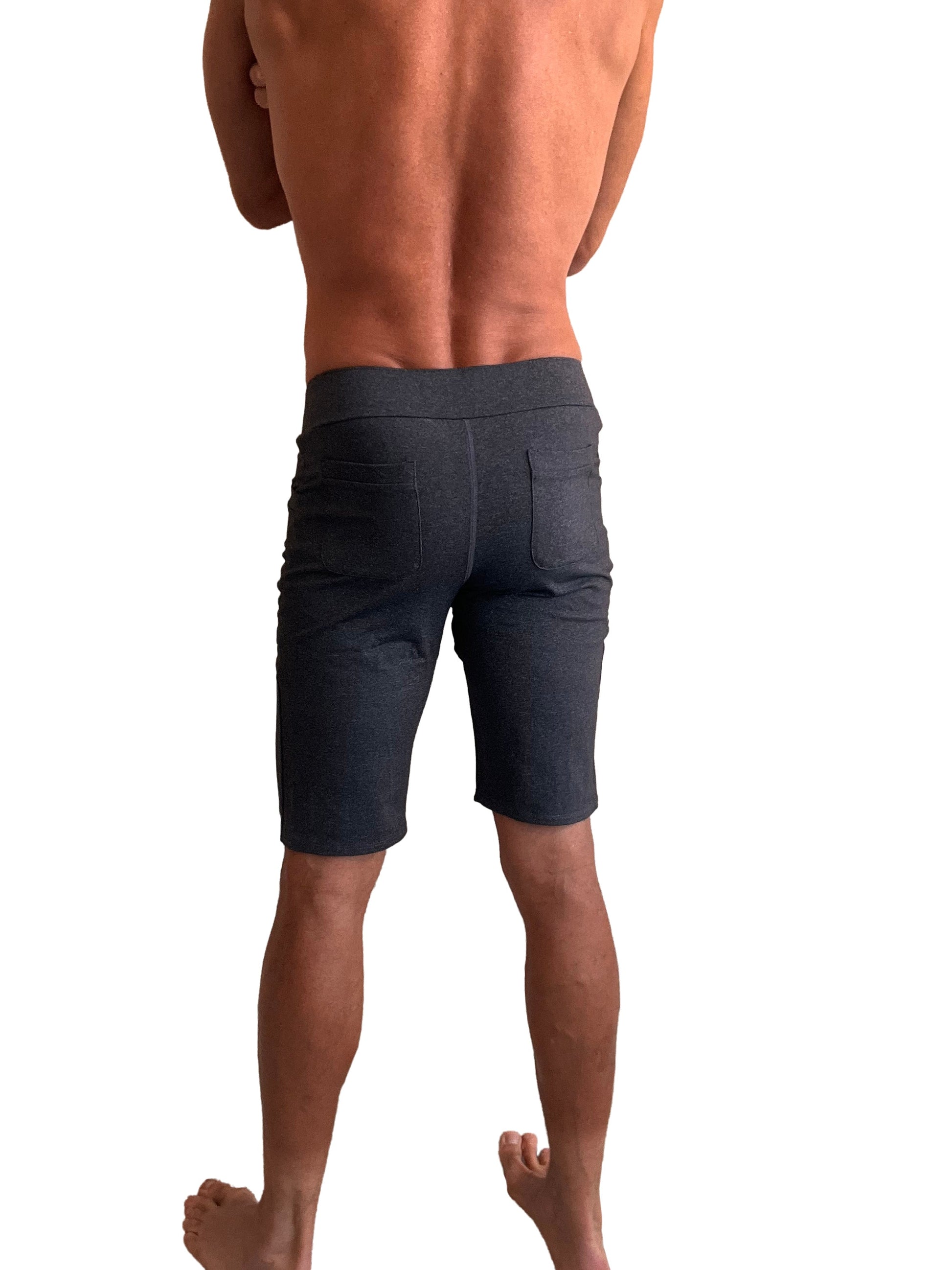 Back view of dark gray stretchy performance premium urban tactical dress shorts with elastic waistband and two pockets