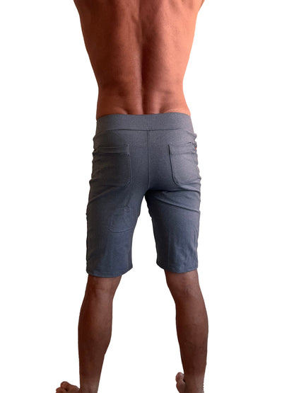 Image of the back side of performance premium urban tactical dress shorts in dark heather grey with elastic waistband and two rear pockets