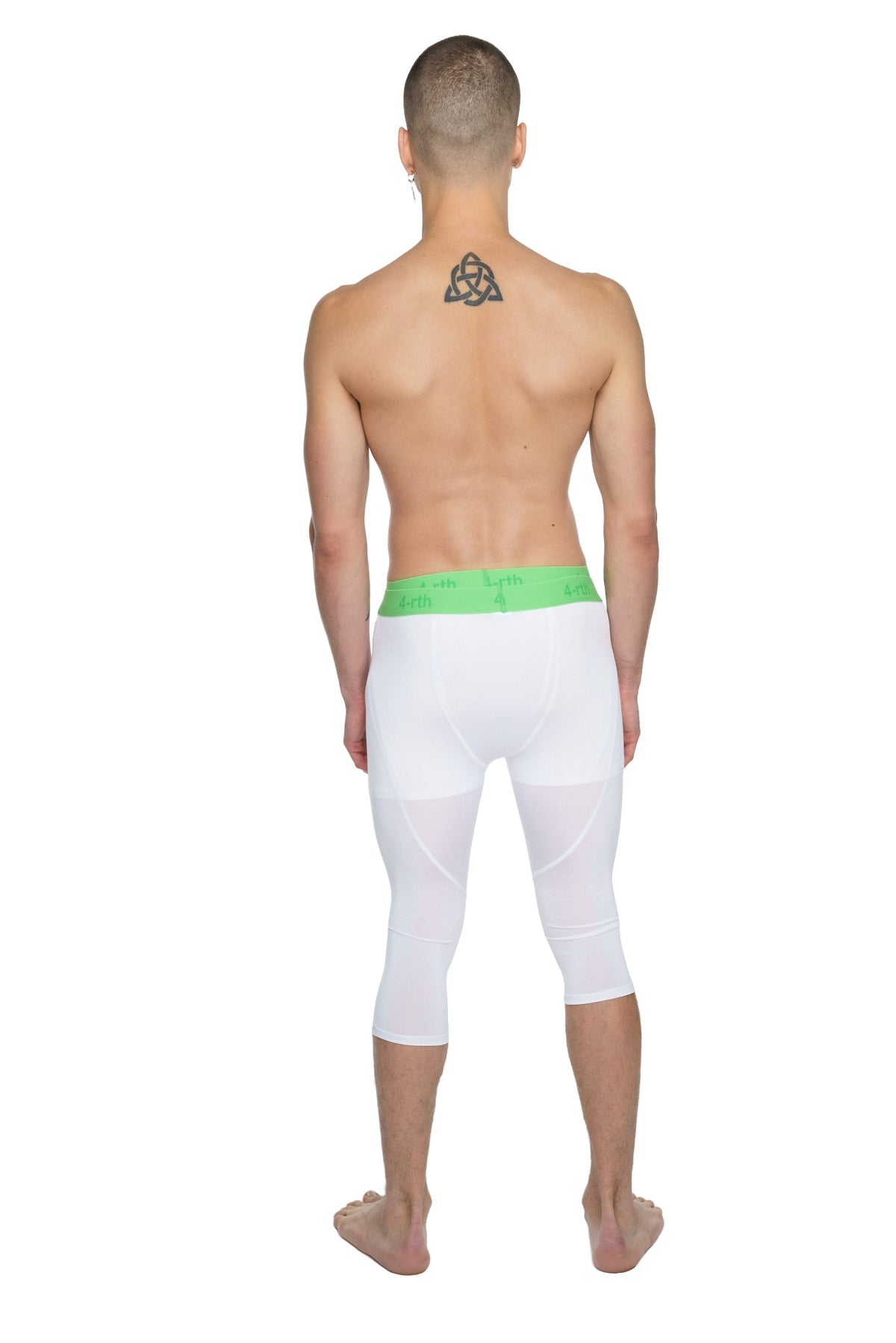 White capri-length performance yoga leggings in arctic white with a bright green elastic waistband for comfort