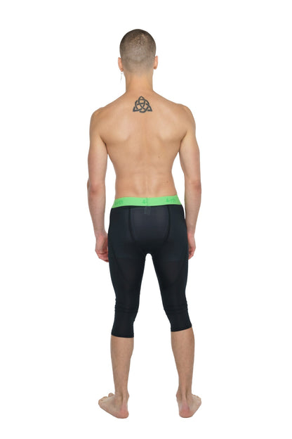 Performance yoga leggings 3/4 in carbon black with bright green waistband designed for compression and flexibility