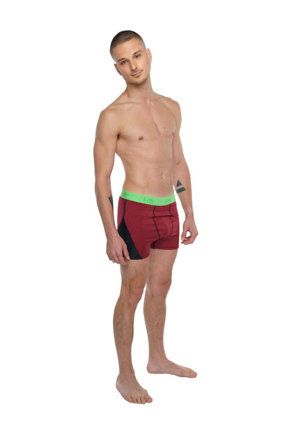 Performance yoga leggings short in brick red heather with maroon and black briefs and bright green waistband visible