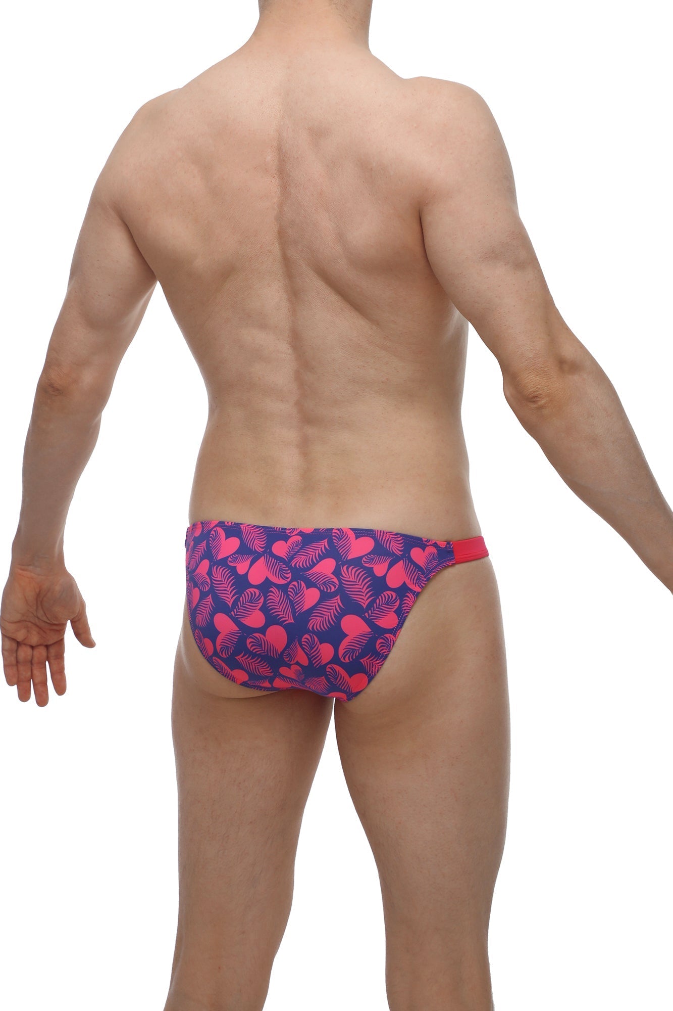 Vibrant pink and navy blue petitq bikini bessas tropical hearts swim trunks with bold heart leaf pattern and red waistband