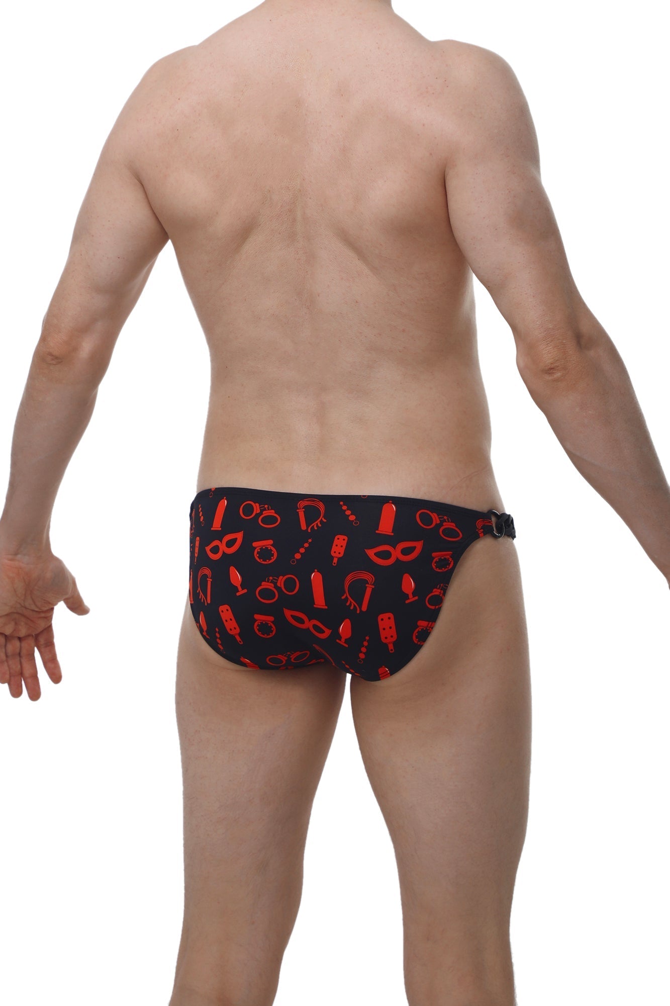 Black swim trunks with bold red playful mask and handcuff pattern from petitq bikini chains boudoir collection