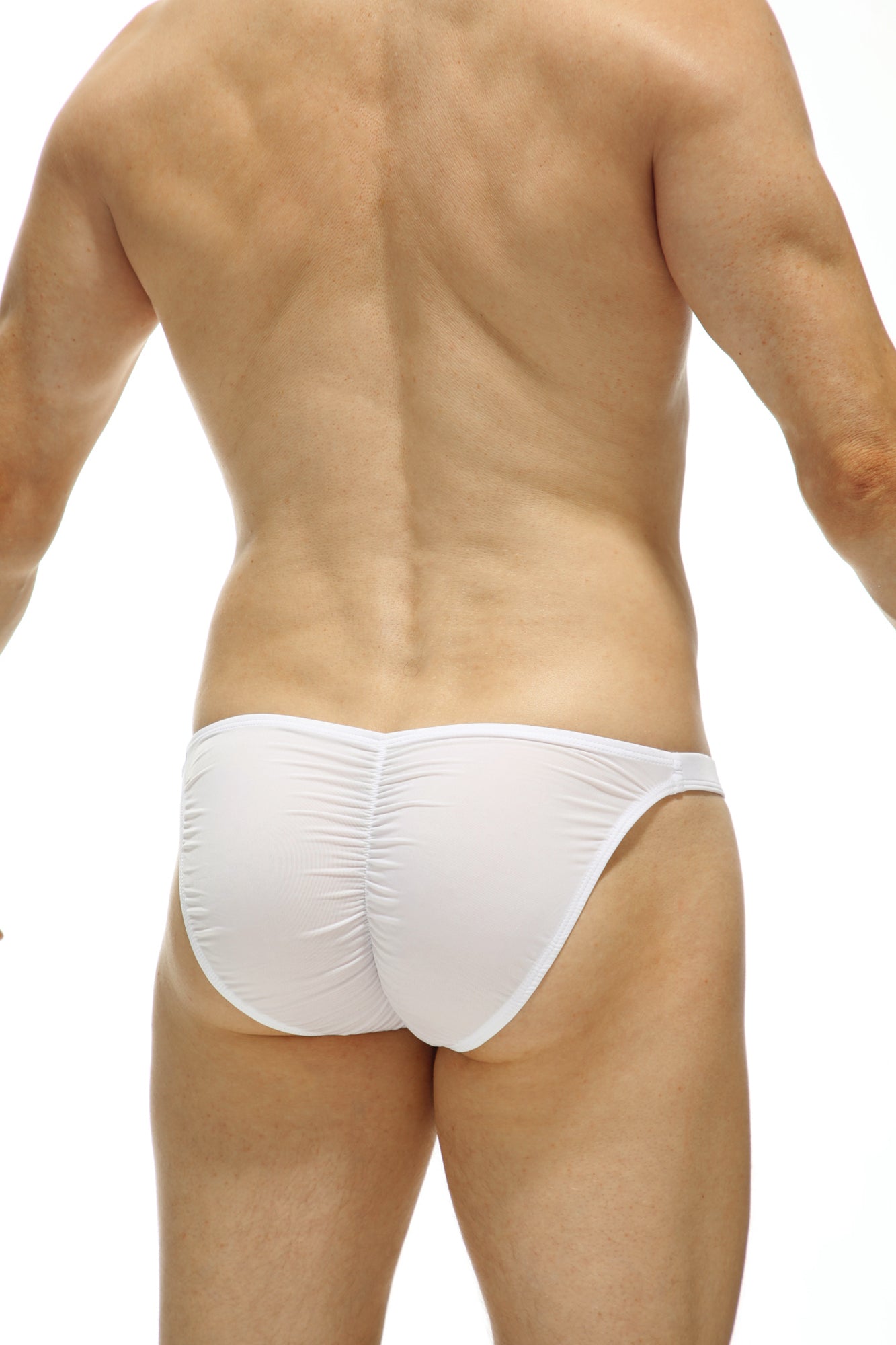 White petitq bikini cornil bulan swim trunks showing ruched back design in form-fitting fabric